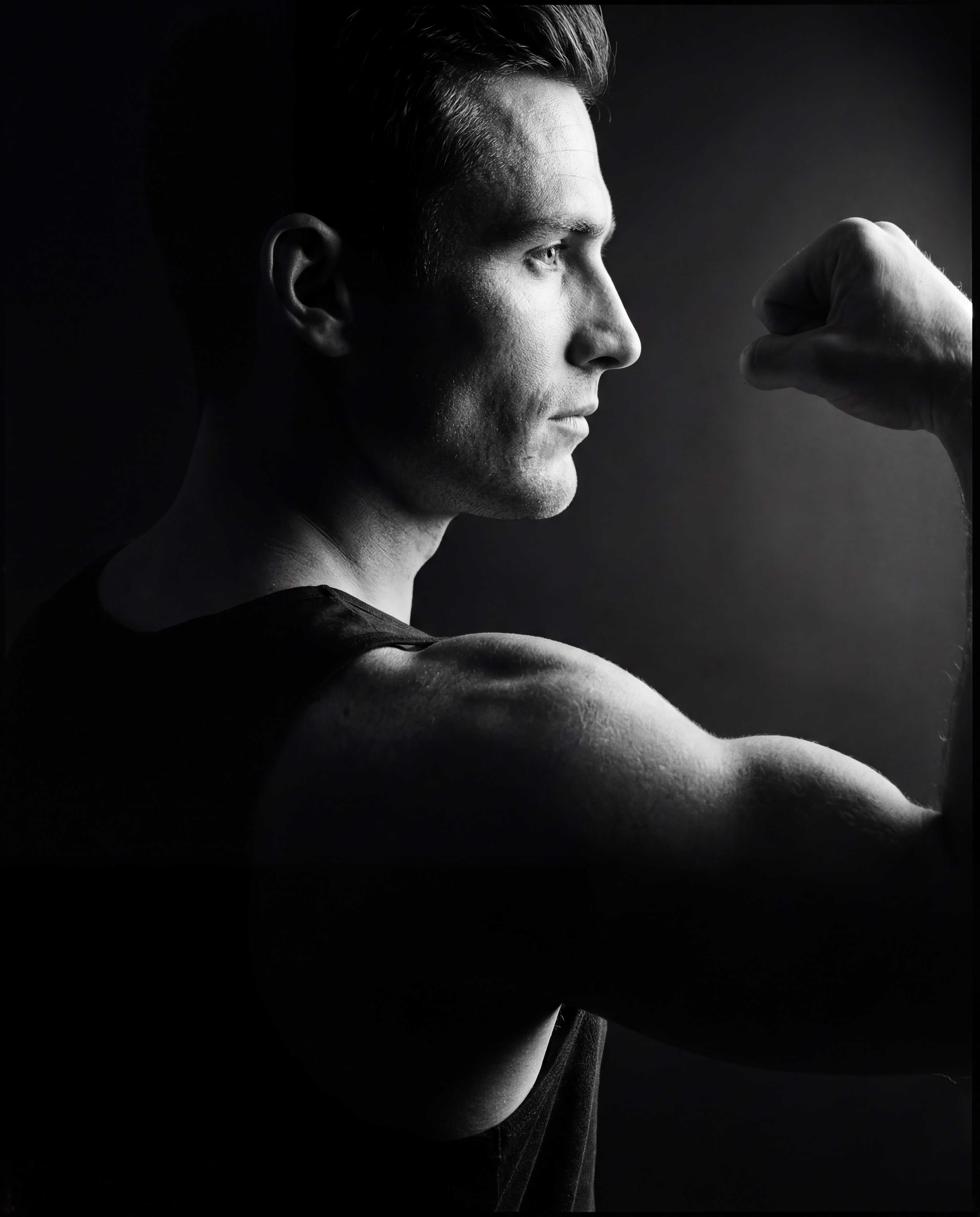 Athletic torso mid-movement under dramatic studio lighting